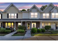 Charming townhome with well-manicured front yard landscaping and inviting covered porch at 122 Brockman Way, Goose Creek, SC 29445