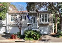 Charming two-story townhouse with a well-maintained yard, white picket fence, and an inviting entryway at 1500 Trumpet Vine Ct, Mount Pleasant, SC 29466