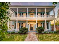Charming two-story home featuring a spacious porch with columns and manicured landscaping at 154 Wentworth St, Charleston, SC 29401