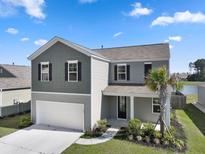 Charming two-story home featuring a two-car garage and beautifully landscaped front yard at 183 Greenwich Dr, Summerville, SC 29486