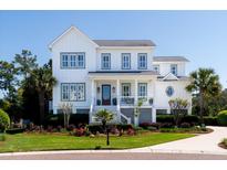 Charming two-story home with landscaped yard, inviting front porch, and a classic white exterior with gray trim at 1905 Lone Oak Pt, Mount Pleasant, SC 29466