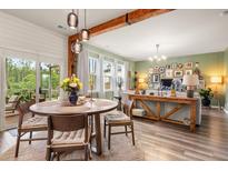 Bright open-concept living and dining area with wood floors and exposed beam at 206 Red Bluff St, Summerville, SC 29483