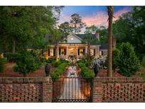 Charming brick home with manicured landscaping and inviting entrance at sunset at 207 Central Ave, Summerville, SC 29483