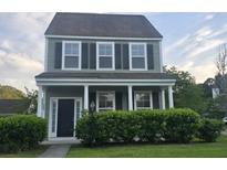 Charming two-story home with a covered front porch and well-maintained landscaping at 209 Killarney Trl, Moncks Corner, SC 29461