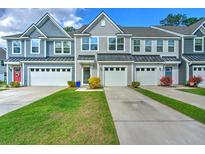 Attractive townhomes showing pleasing color schemes, attached garages, and nicely manicured front lawns at 210 Grand Palm Ln, Summerville, SC 29485