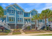 Charming light blue townhome with tropical landscaping and inviting front entrances at 2302 Hamlin Sound Cir, Mount Pleasant, SC 29466
