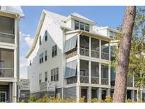 Beautiful multi-story beach home featuring screened-in porches and durable metal roofing at 2568 Helmsman Rd, Johns Island, SC 29455