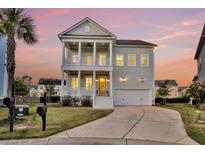 Stunning two-story home with double porches, columns, a two-car garage and a beautifully landscaped lawn at 2906 Quarterdeck Ct, Mount Pleasant, SC 29466