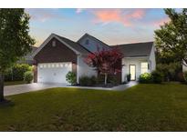 Charming single-Gathering home with brick and siding, showcasing a well-manicured lawn and attached two-car garage at 3133 Cold Harbor Way, Charleston, SC 29414