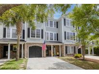 Charming townhome with a brick-accented facade, attached garage, and welcoming curb appeal at 4020 Conant Rd, Mount Pleasant, SC 29466
