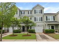 Attractive townhome featuring well-manicured landscaping, a one car garage, and a welcoming front entrance at 4143 Rigsby Ln, Charleston, SC 29414