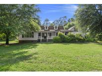 Charming single-Gathering home with a well-manicured front yard and covered front porch with dormers at 520 Givhans Rd, Ridgeville, SC 29472