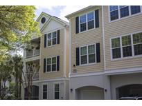Inviting townhouse with classic curb appeal, featuring a charming balcony and well-maintained landscaping at 60 Fenwick Hall Aly # 937, Johns Island, SC 29455