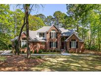 Charming brick home with manicured lawn and lush landscaping, creating a welcoming curb appeal at 1855 Cherokee Rose Cir, Mount Pleasant, SC 29466