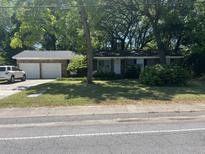 Charming single story brick home with an attached two car garage and mature trees at 1866 Ashley Hall Rd, Charleston, SC 29407