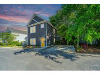 Charming two-story home with a yellow front door, neat landscaping and private driveway at 2130 Weaver St, Charleston, SC 29403