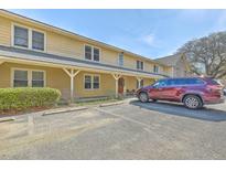 Two-story home with covered entryway, ample parking and a red SUV in the lot at 2150 Spoleto Ln # B-11, North Charleston, SC 29406