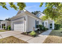 Charming home featuring a well-maintained lawn, two car garage, and attractive curb appeal at 239 Sea Lavender Ln, Summerville, SC 29486