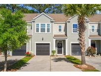 Charming townhome featuring a private entrance, garage, and well-manicured landscaping at 2505 Stadium Dr, North Charleston, SC 29406