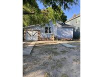 Charming bungalow with light blue siding, brick foundation, and garage with stylish barn doors at 3364 Osceola St, North Charleston, SC 29405