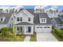 Charming two-story home featuring a welcoming front porch and a two-car garage at 361 Ripple Park Dr, Summerville, SC 29486