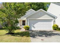 Charming home featuring a two-car garage, well-kept lawn, and lovely curb appeal at 3802 Annapolis Way, Ladson, SC 29456