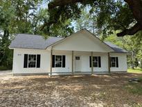 Charming single-story home featuring a covered porch and black shutters, perfect for relaxed southern living at 419 Ravenwood Rd, Walterboro, SC 29488
