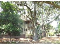Beautiful home exterior surrounded by mature trees and a well-manicured landscape at 855 Club Cottage Rd, Edisto Island, SC 29438