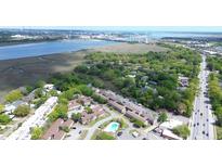 An aerial view of a townhouse community near the water and downtown, surrounded by lush greenery at 870 Colony Dr # A6, Charleston, SC 29407