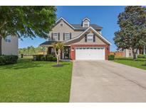 Charming two-story home with a well-manicured lawn, a two-car garage, and beautiful landscaping at 118 Netherfield Dr, Summerville, SC 29486