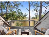 Relaxing balcony with seating area overlooking serene marsh views and lush greenery, perfect for enjoying the outdoors at 1502 Marsh Haven, Seabrook Island, SC 29455