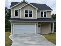 Charming two-story home with a front-facing garage, neutral siding, and well-manicured lawn at 1518 Stanwick Dr, Johns Island, SC 29455
