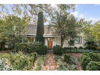 Charming home with lush landscaping, brick path, and a vine-covered chimney, creating a welcoming curb appeal at 2137 Wappoo Dr, Charleston, SC 29412