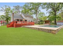 Expansive backyard featuring a swimming pool, deck, and lush green lawn perfect for outdoor enjoyment at 22 Monte Sano Dr, Hanahan, SC 29410