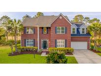 Stunning brick home featuring lush landscaping, attached garage and welcoming entrance at 2524 Deer Walk Way, Mount Pleasant, SC 29466