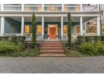 Charming two-story home with a covered porch, landscaped yard, and inviting front door at 66 Warren St # Main House Only, Charleston, SC 29403