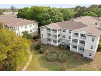Apartment building featuring multiple levels, balconies, and well-maintained landscaping at 700 Daniel Ellis Dr # 3208, Charleston, SC 29412