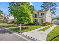 Charming two-story home with a well-manicured lawn and a paved driveway at 8956 N Red Maple Cir, Summerville, SC 29485
