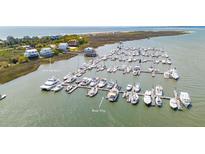 Enjoy this aerial view of the marina featuring boat slips and the nearby waterfront homes at 0 We 10Th St, Folly Beach, SC 29439