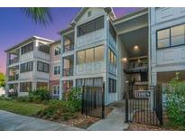 Inviting condo building featuring multi-level balconies and manicured landscaping at 1025 Riverland Woods Pl # 1108, Charleston, SC 29412