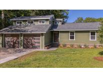 Charming home with a modern two-car garage, natural siding, and a well-manicured lawn at 1049 Bradford Ave, Charleston, SC 29412