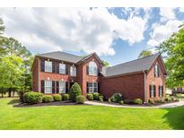 Beautiful two-story brick home with a manicured lawn, dark shutters, and mature landscaping at 105 Kirkhaven Ct, Goose Creek, SC 29445