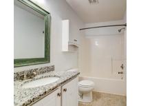 Well-lit bathroom with white cabinets, granite countertops, and a shower-tub combo at 118 Willowbend Ln, Summerville, SC 29485