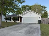 Charming single-story home featuring a two-car garage, red front door, and a well-maintained front yard at 1341 Belle Grove Cir, Hanahan, SC 29410