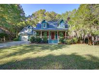 Charming two-story home featuring a spacious front porch and well-manicured lawn at 1417 Pine Island View, Mount Pleasant, SC 29464