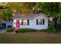 Charming single-story home with a bright pink front door, black shutters, and a well-maintained lawn at 1450 E Montague Ave, North Charleston, SC 29405