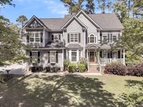 Charming two-story home featuring a welcoming front porch, manicured lawn, and classic architectural details at 1828 S James Gregarie Rd, Mount Pleasant, SC 29466