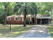 Charming single story home with brick and light-colored siding with a large palm tree in the front yard at 202 Easy, Goose Creek, SC 29445