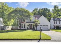 Charming two-story home with well-manicured lawn, mature trees, and attached garage at 2021 Beckton St, North Charleston, SC 29420