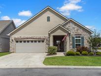 Charming single-story home featuring stone accents, a two-car garage, and well-maintained landscaping at 222 Stone Village Cir, Summerville, SC 29486